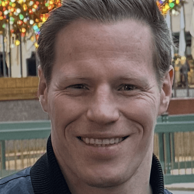 Headshot of Michael Pieper with a city background